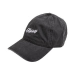 The Odyssey Slugger Cap is a black 6-panel hat with the word "Odyssey" embroidered in white on the front, featuring a convenient strap back for adjustable comfort.