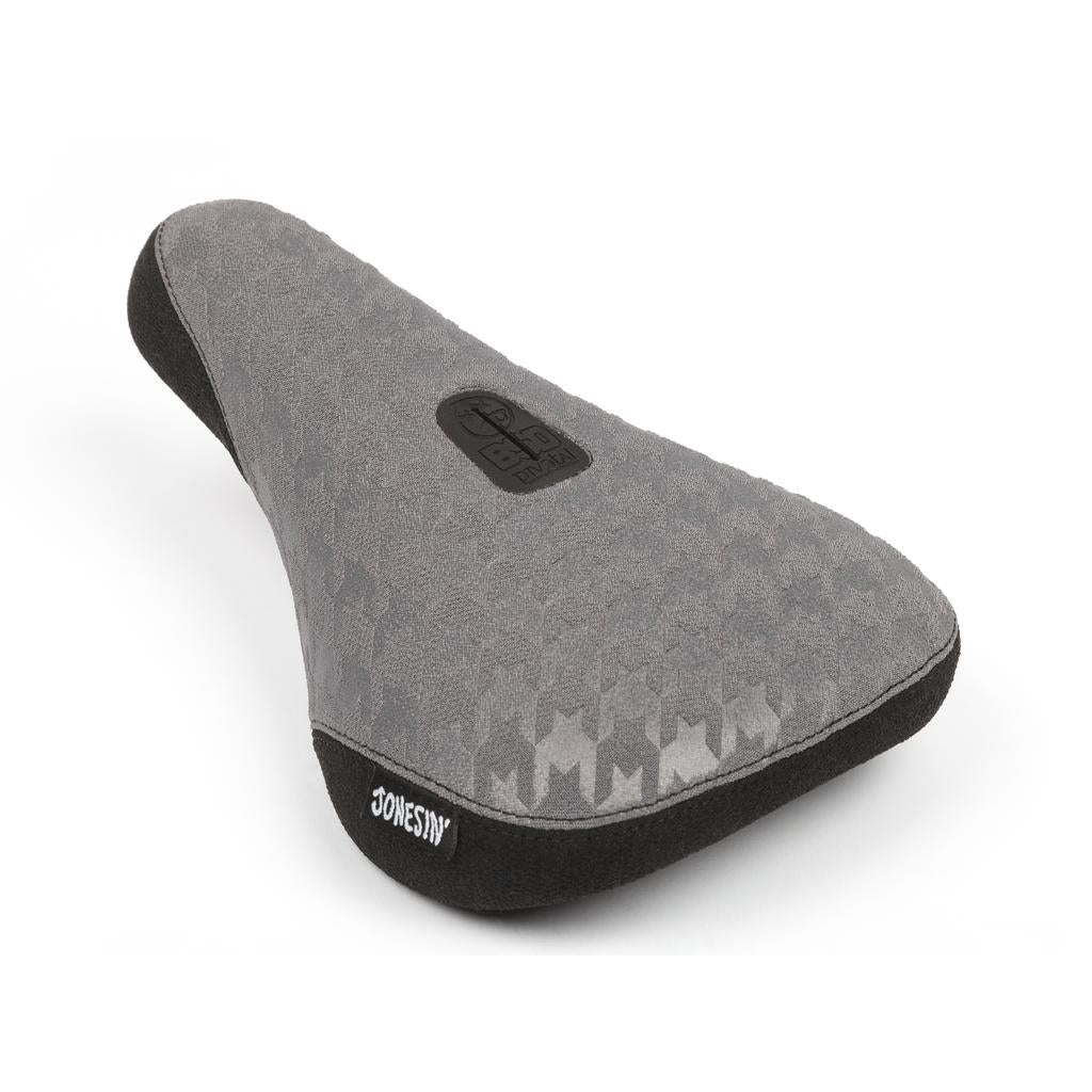 The BSD Jonesin Pivotal Seat features a gray houndstooth pattern, black trim, Kevlar bumpers for durability, and Sam Jones' signature on top.