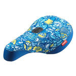 The Odyssey IG Hot Seat, a bike seat featuring a blue and yellow color scheme with a vibrant abstract design and a small red tag labeled "ODSY," adds an eccentric touch.