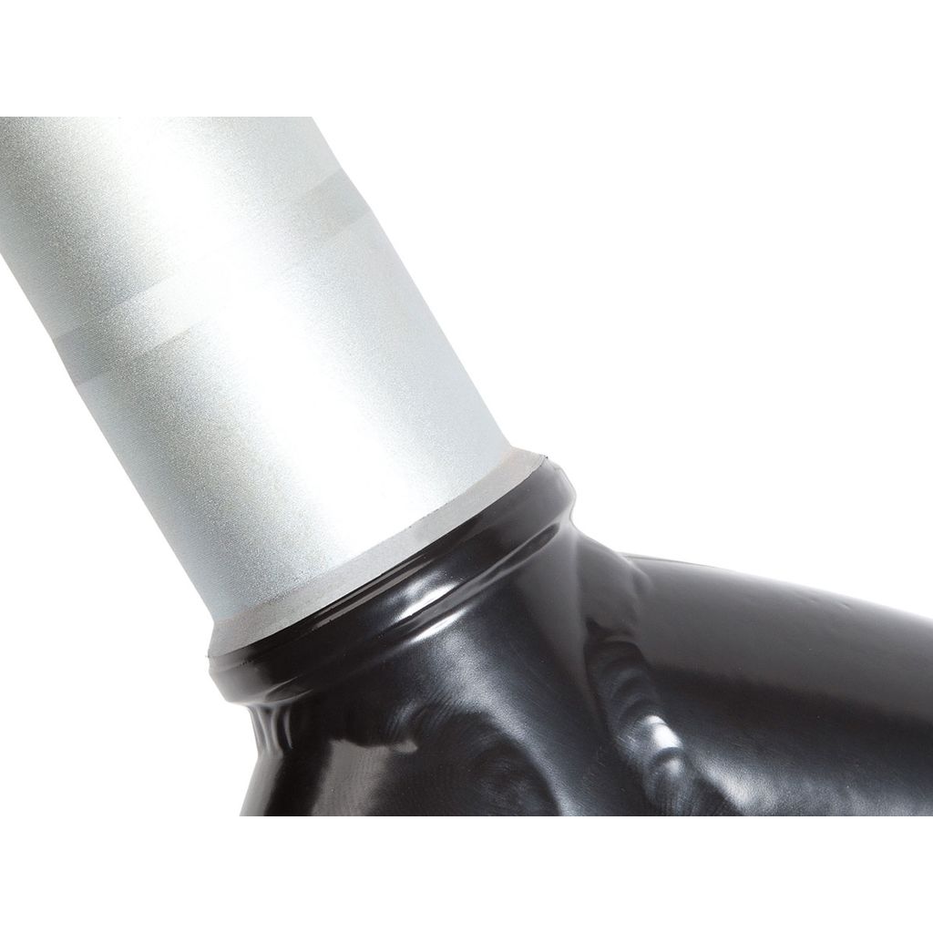 A close-up of the S&M Pitchfork XLT 24 Inch Fork, featuring a glossy black and silver CNC-machined metal joint. The image highlights its smooth connection and reflective surfaces, suggesting it might be part of a pipe or exhaust system.