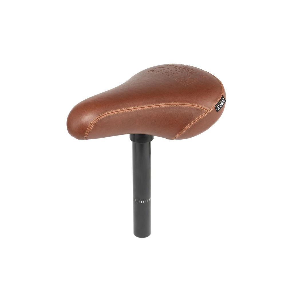 The Radio Century Combo Seat is a brown leather bicycle saddle with durable material, a black seat post, and lightweight fat foam padding for added comfort, isolated on a white background.