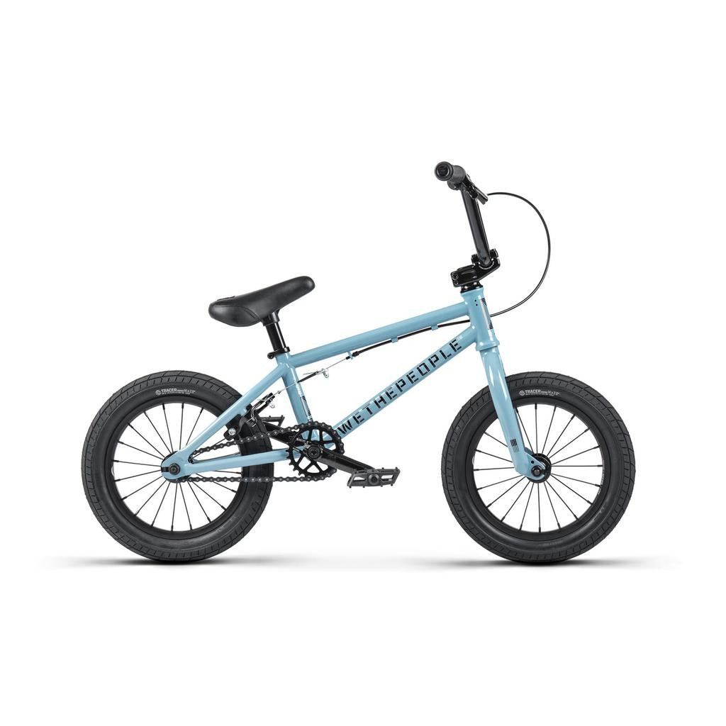 The Wethepeople Riot 14 Inch BMX Bike is a compact blue model with black handlebars, seat, and 14" wheels, stylishly viewed from the side.