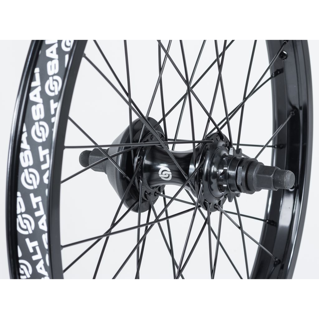 Close-up of a bicycle wheel with black spokes and a sleek black central hub, featuring Salt EX Cassette Rear Wheel branding on the single wall rim.