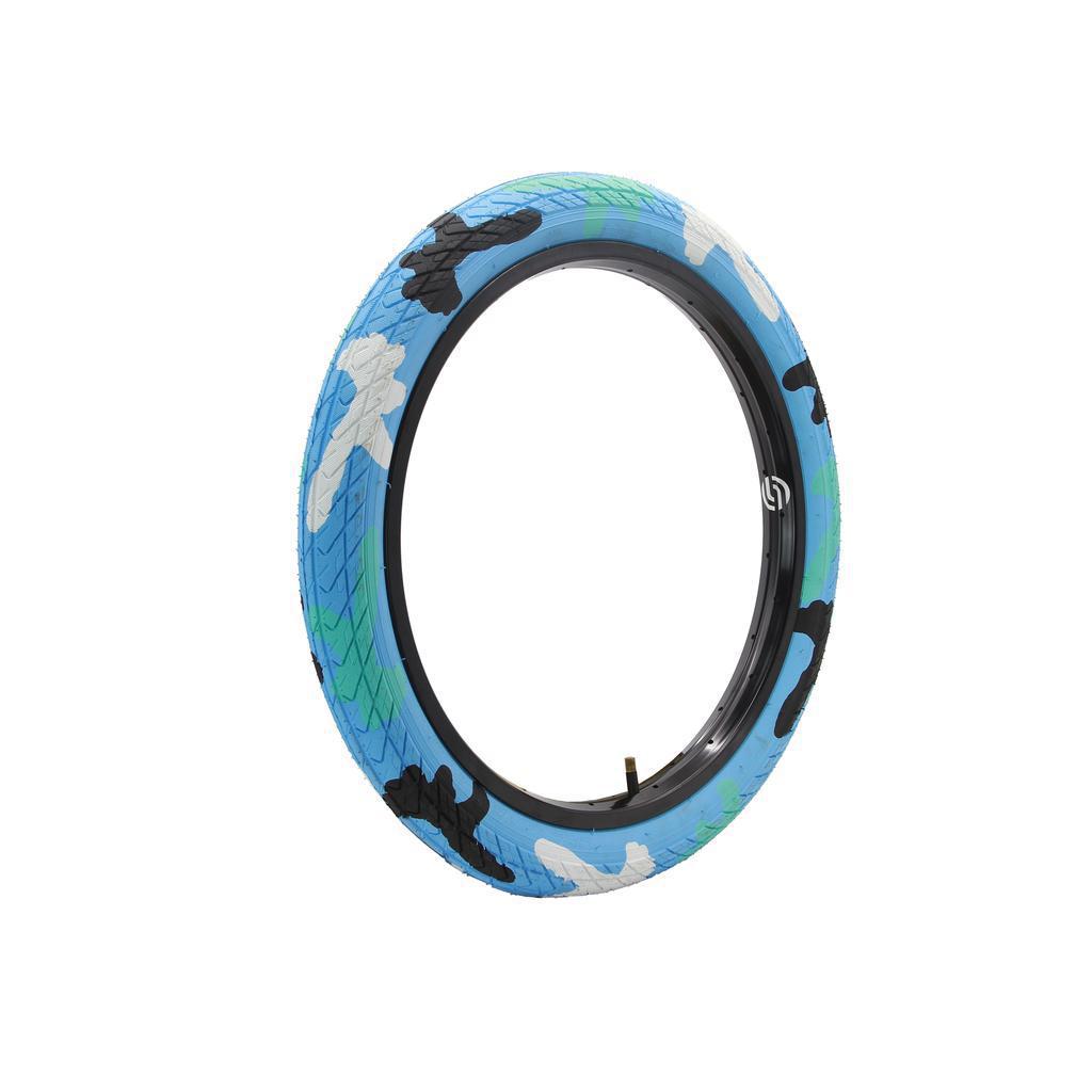 The DRS Arrow FS 20 Inch Tyre, featuring a camouflage pattern in blue, white, green, and black, is set against a white background.