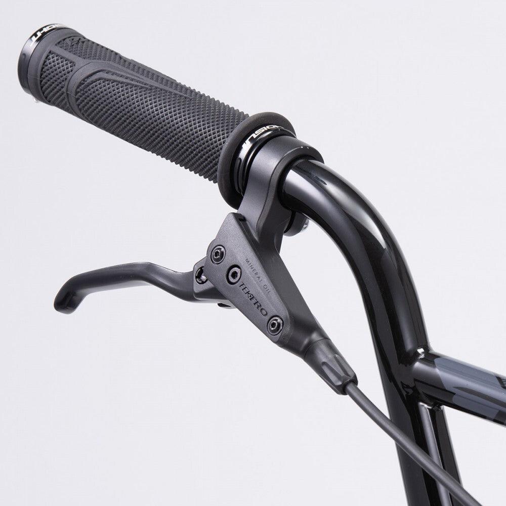 Close-up of a Chase Element Expert Bike handlebar with textured grip and a Tektro brake lever on an Expert XL frame. The brake cable is attached, and the background is plain gray.