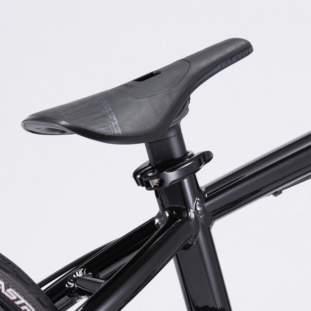 Close-up view of the saddle and the top part of the seat post on a black Chase Element Expert Bike.