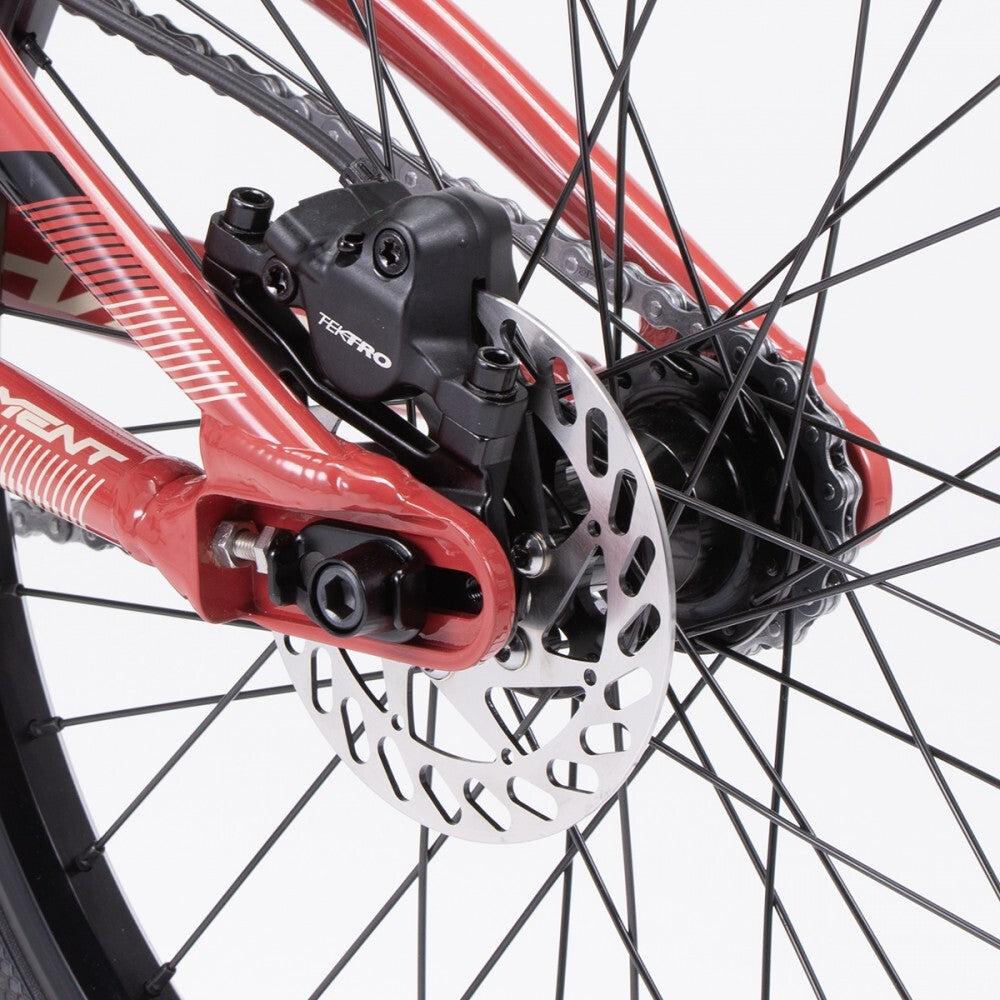 Close-up of the Chase Element Pro XXXL Bike's rear wheel showcasing the red frame, disc brake with a silver rotor, and black caliper.