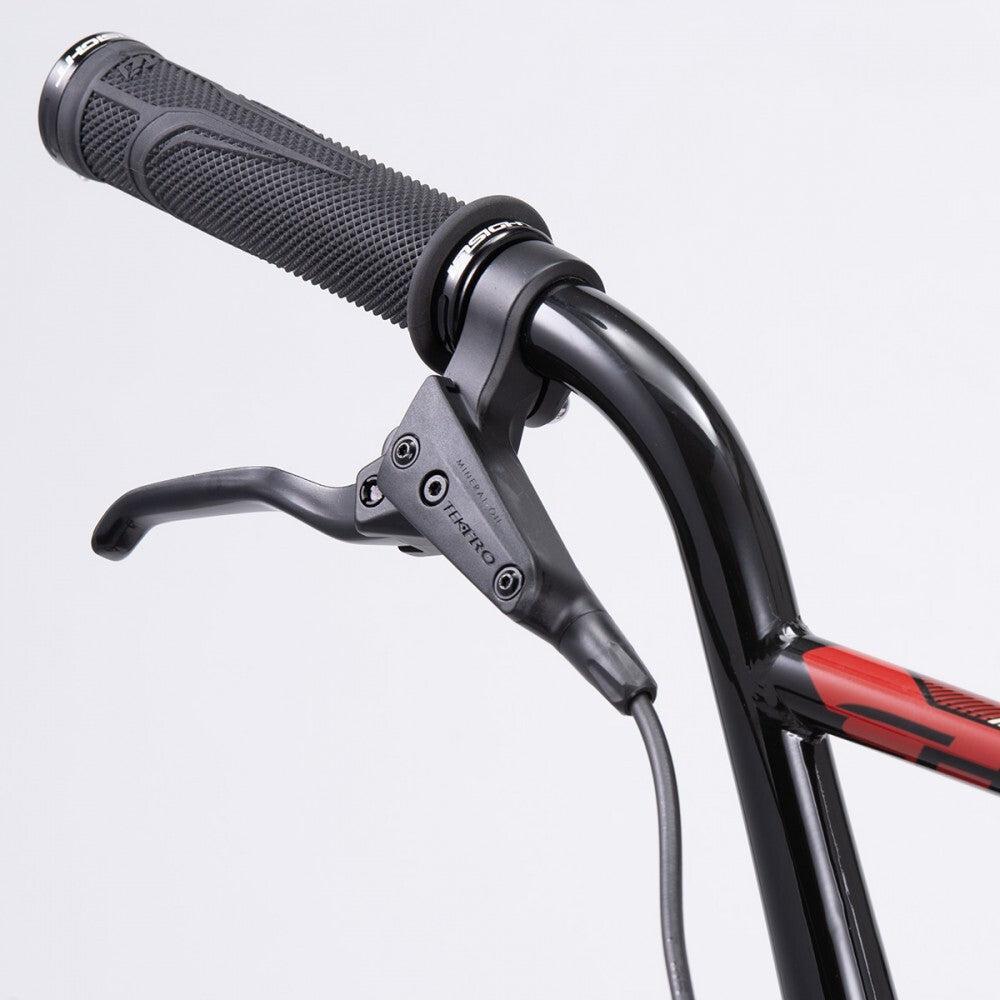 Close-up of the Chase Element Pro XXL Bike's handlebar with a black grip and an attached brake lever, showcasing the "Tektro" brand. The handlebar exhibits a striking red and black design, perfectly complemented by Ikon carbon forks for superior performance.