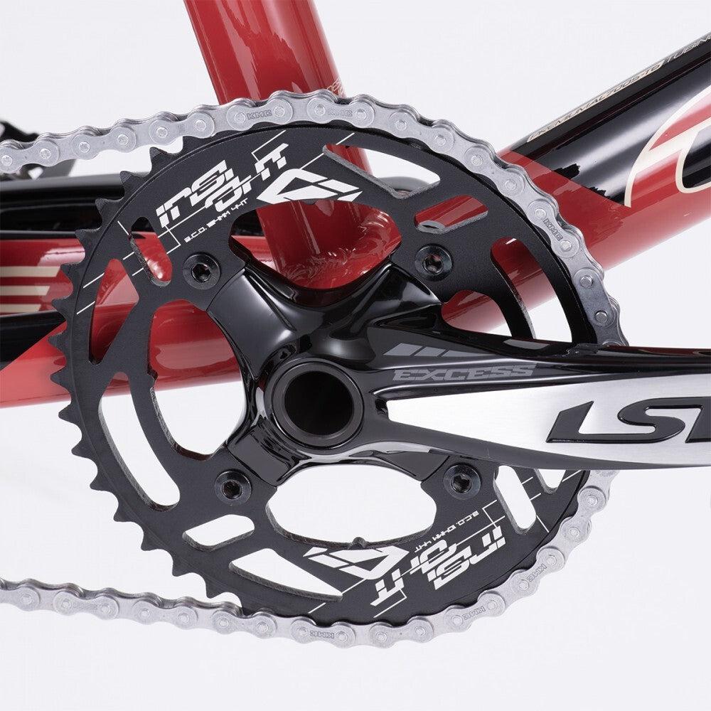 Close-up of the crankset on a red Chase Element Expert Bike, featuring a black chainring with "Insight" and "LT" logos and a silver chain.