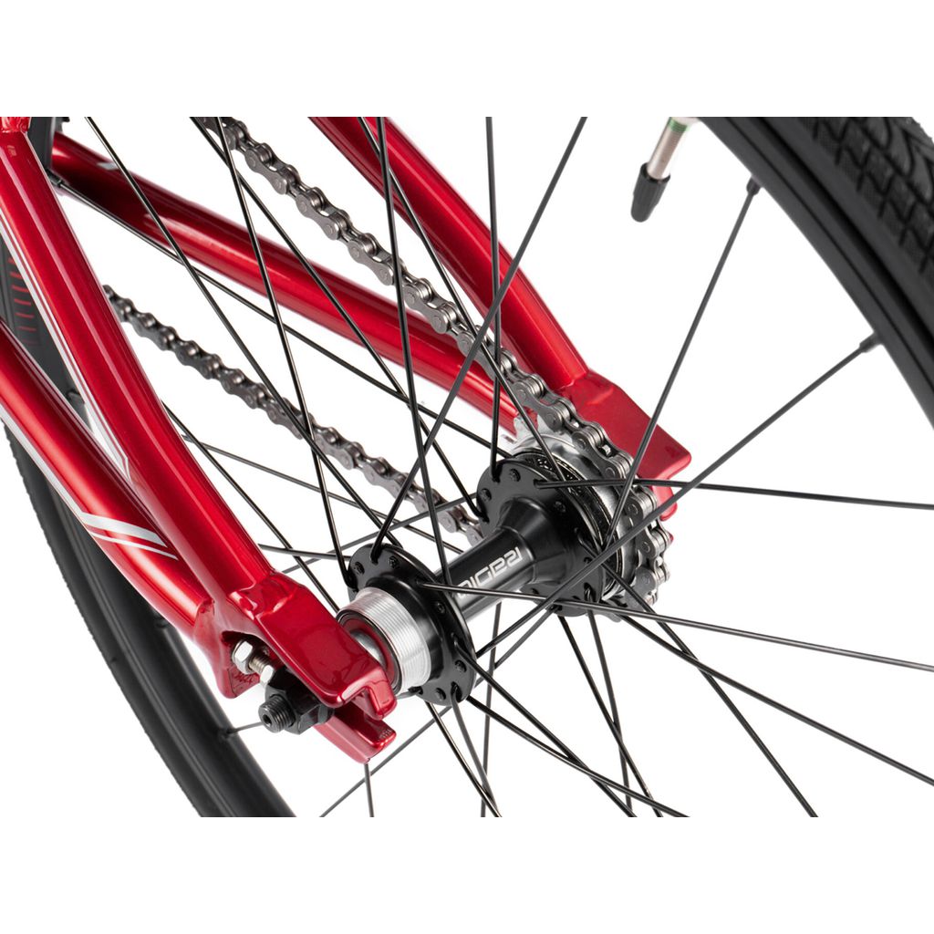 Close-up of a red Radio Cobalt Mini Bike wheel featuring the rear spokes, chain, and hub against a white background, reminiscent of the sleek design seen in BMX racing.