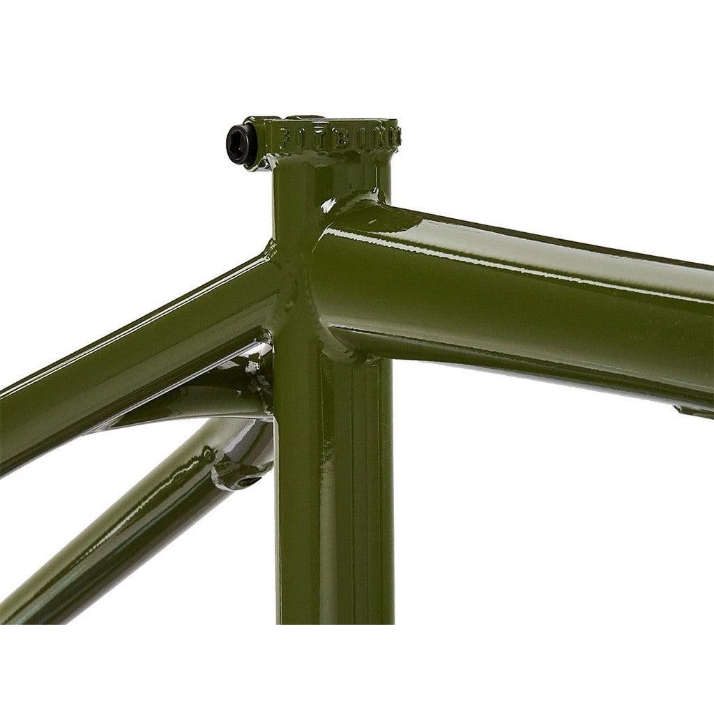 Close-up of the green Fit Bike Co Shortcut Frame, focusing on the top tube, seat tube, and seat stay joints. The responsive frame's welds and smooth finish are clearly visible, making it ideal for tech riders.