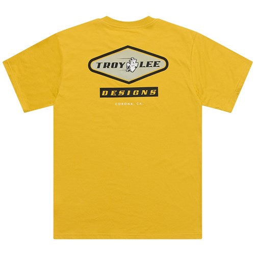 The TLD 25.1 Carb SS T-Shirt features a yellow color with the "Troy Lee Designs" logo and "CORONA, CA" text on the back. Show off your love for TLD with this bold design.