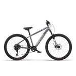 A side view of the Radio 26 Inch Zuma Sus Bike, featuring a grey and black color scheme, lightweight alloy frame, front suspension fork, disc brakes, and knobby tires.