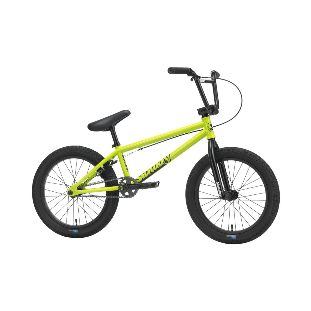 The Sunday Primer 18 Inch Bike (2025) is a bright yellow BMX bike with black handlebars and seat, featuring thick tires, an Odyssey Springfield brakes system, and a compact frame.