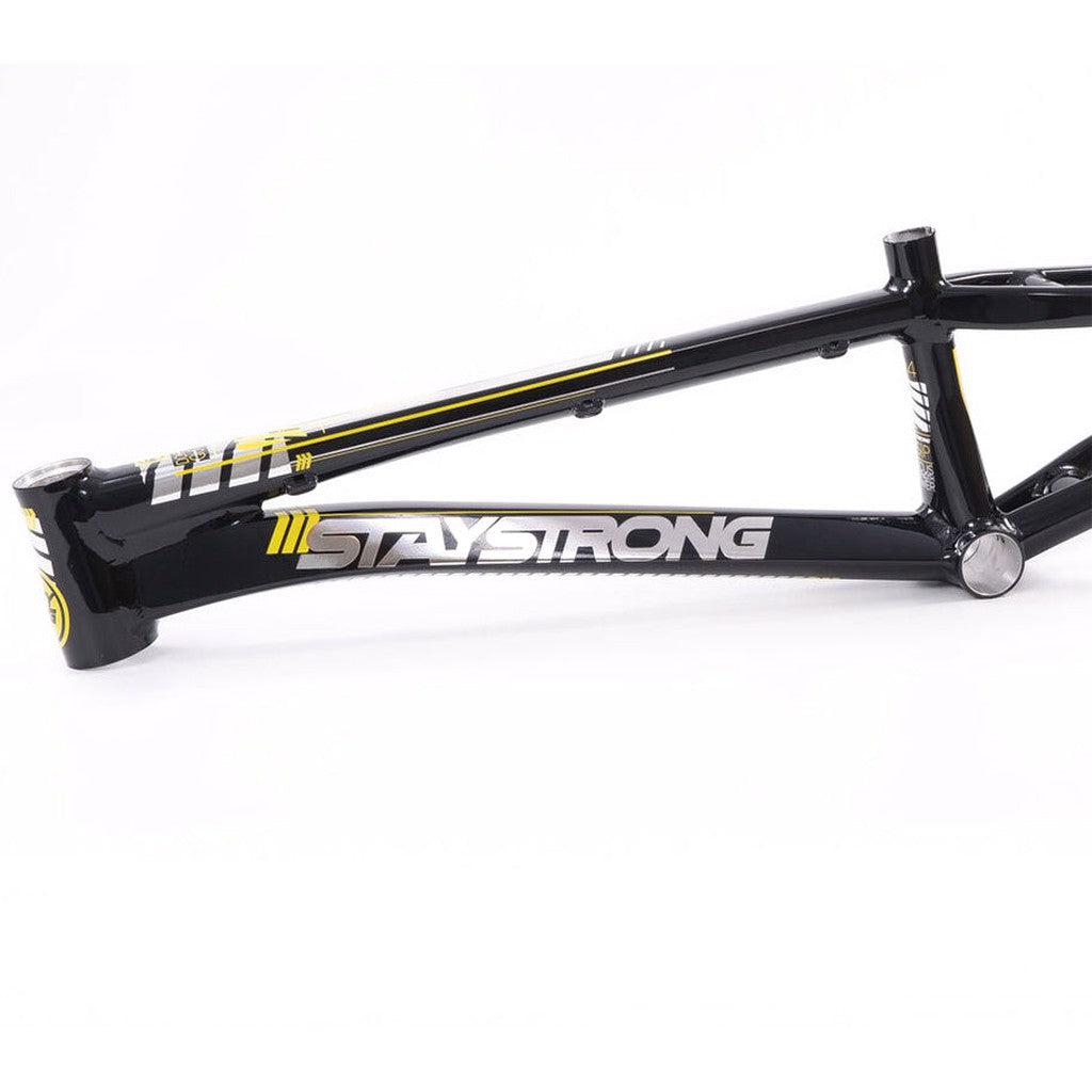 Close-up of a black Staystrong V4 Frame Expert XL Cruiser, featuring "STAY STRONG" written in bold white letters with yellow accents along the side.