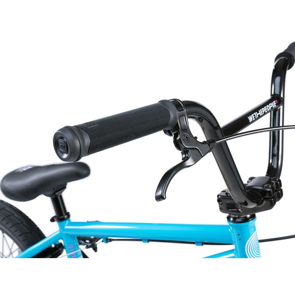 Close-up of a Wethepeople Seed 16 Inch Bike in blue, featuring handlebar with black grips, brake lever, and part of the seat—ideal for any BMX enthusiast.