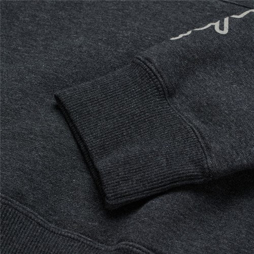 Close-up of a TLD 25.1 Stamp Hoodie sleeve, dark gray with ribbed cuff and partial white text, ideal for chilly winter days.