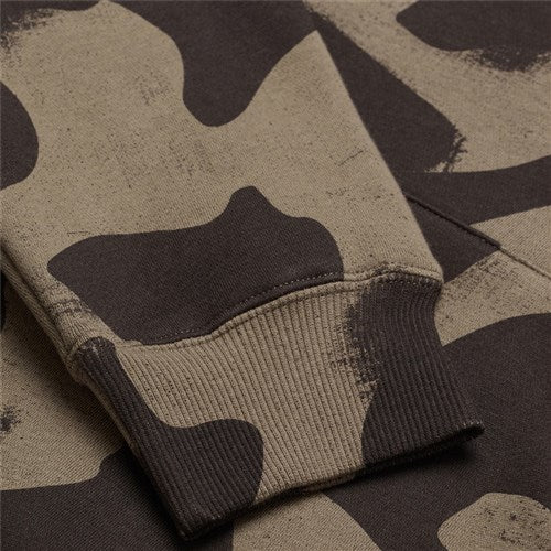 Close-up of camouflage fabric in green and brown with visible stitching on a sleeve cuff, perfect for the versatile TLD 25.1 Signature Pull Over Hoodie that adds a unique touch to any wardrobe.