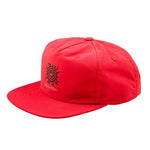 The TLD 25.1 Enjoy Unstructured Hat is a red baseball cap adorned with a striking black sun and eye design on the front.