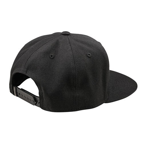 The TLD 25.1 Badge Hat is a sleek black baseball cap with a flat brim and adjustable snapback, showcased stylishly when worn backward.