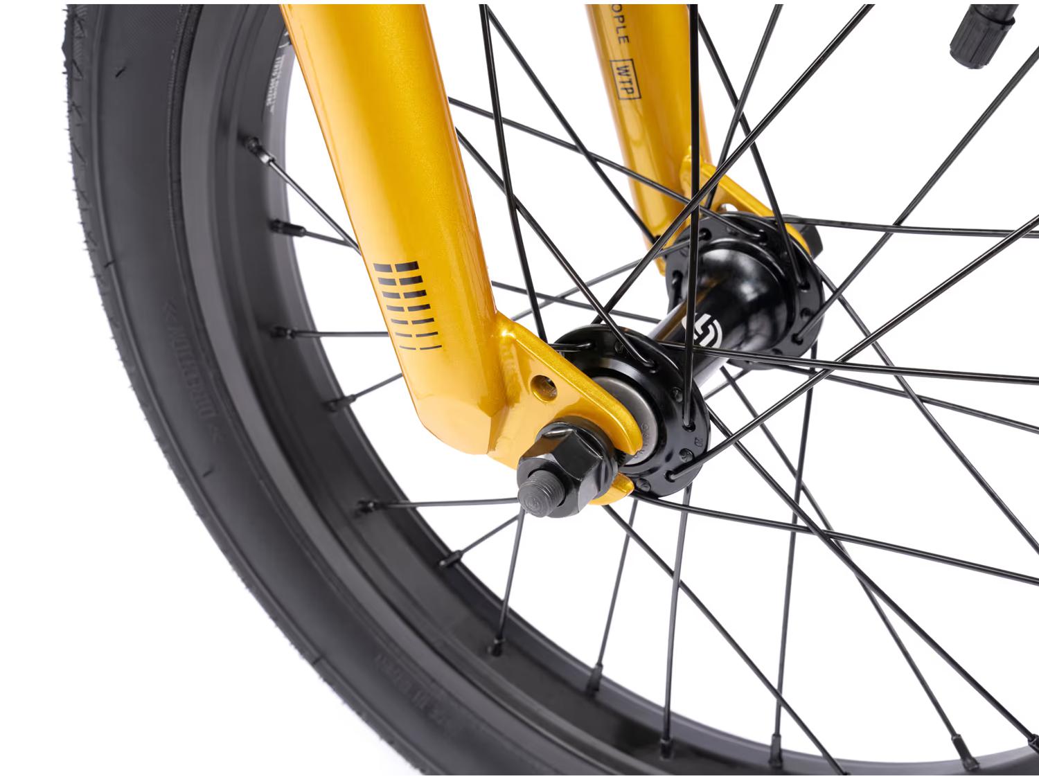 Close-up of a yellow bicycle fork and wheel with black spokes and a "Kenda" tire, showcasing the robust durability of the Wethepeople Seed 16 Inch Bike. Ideal for BMX shredders ready to elevate their biking adventures.