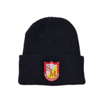 The S&M Ribbed Cuffed Beanie is a black knit hat made from hypoallergenic acrylic, featuring an embroidered red and yellow patch with the initials "S&M" and the words "American Bicycle Co."—ideal for style-conscious cyclists.