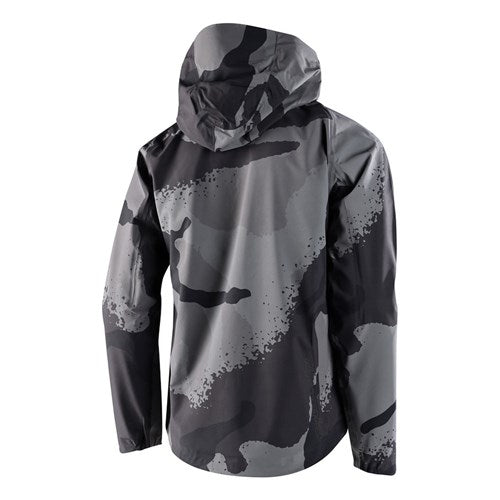 The TLD Descent Jacket showcases a black and gray camo design with a hood, featuring a 3-layer membrane for top-notch protection. Stylish and waterproof when viewed from behind, it's ideal for any adventure.