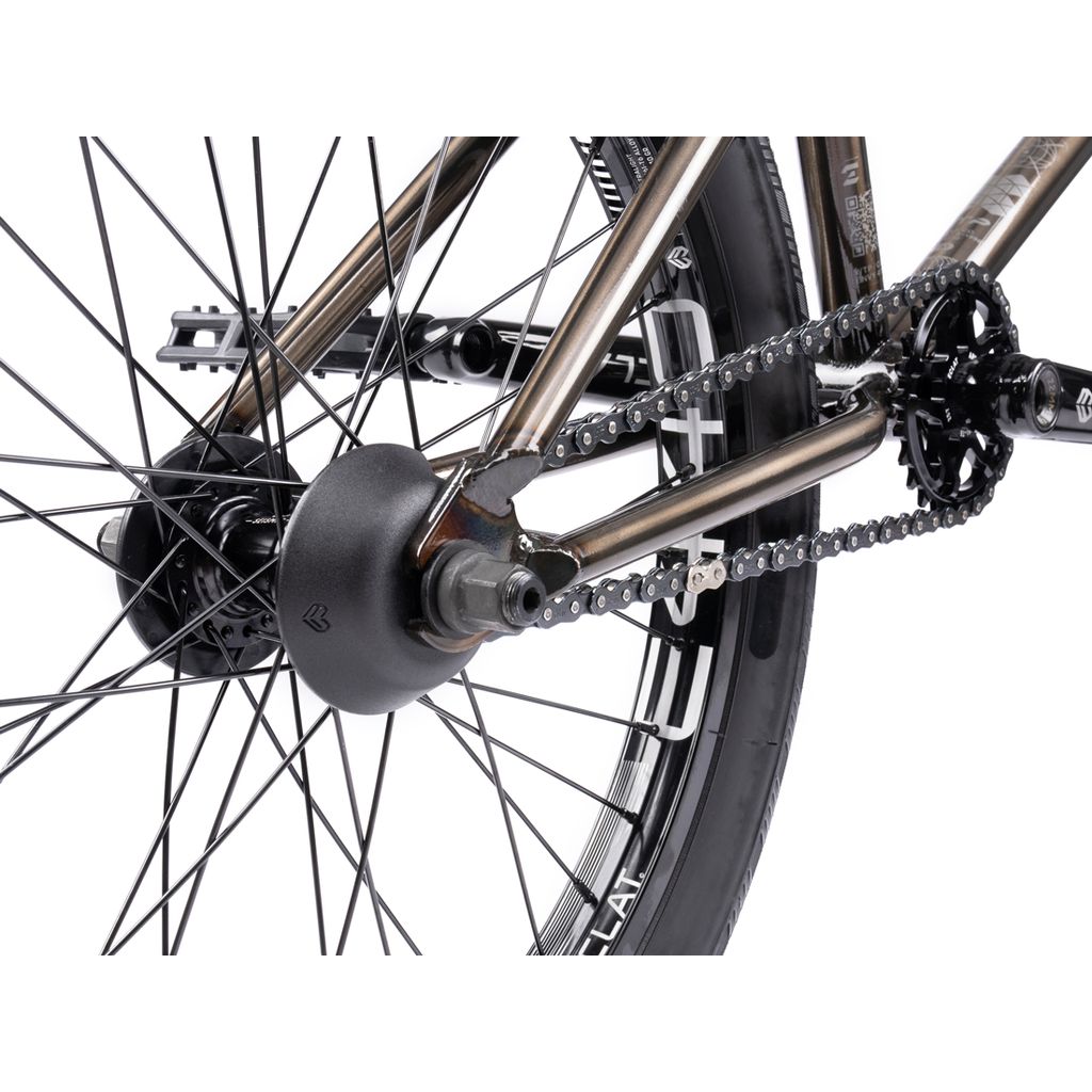 Close-up of a BMX bike's rear wheel highlighting the sturdy Chromoly frame, spokes, gear sprocket, chain, and axle—a testament to the craftsmanship of the Wethepeople Envy 20 Inch BMX Bike.