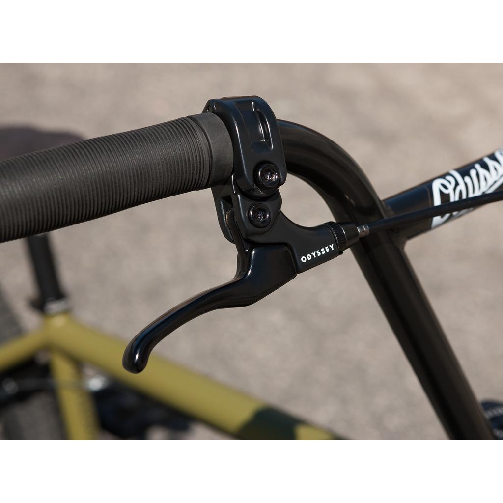 Close-up of a black Odyssey brake lever from the premium collection, attached to handlebars wrapped with textured black grips similar to those Gary Young favors, on the Sunday Wave Length 20 Inch (Gary Young) bike.