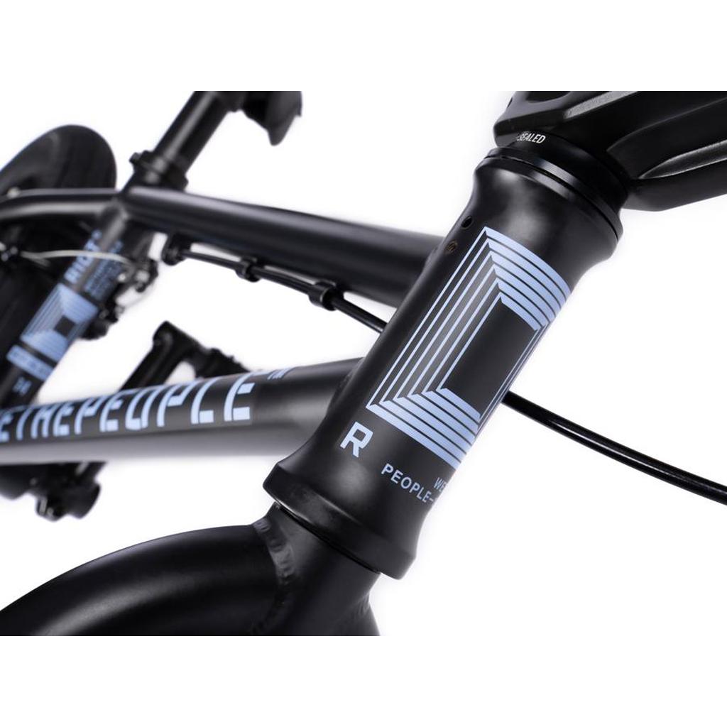 Close-up of the Wethepeople Riot 14 Inch BMX Bike frame, illustrating its sleek black design with blue geometric patterns and text, ideal for BMX enthusiasts.