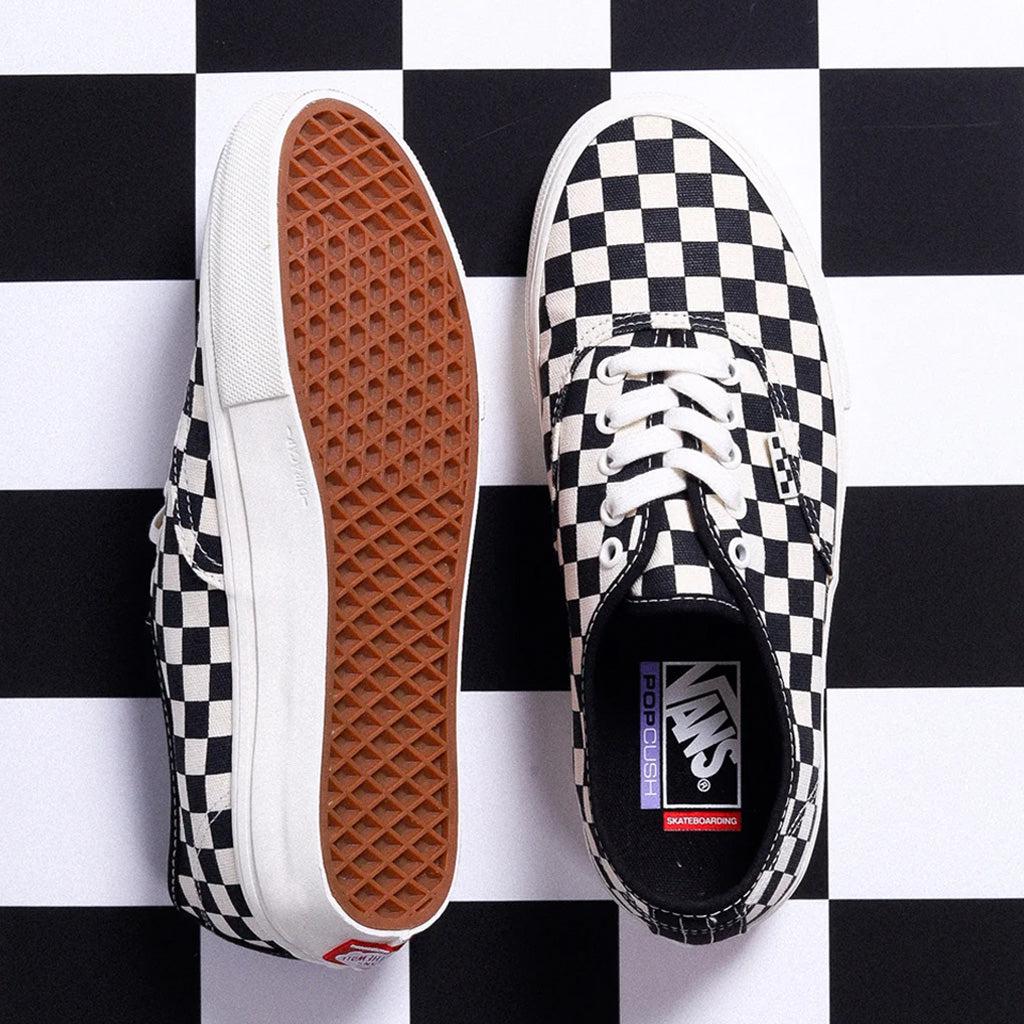 Black checkered clearance vans on feet