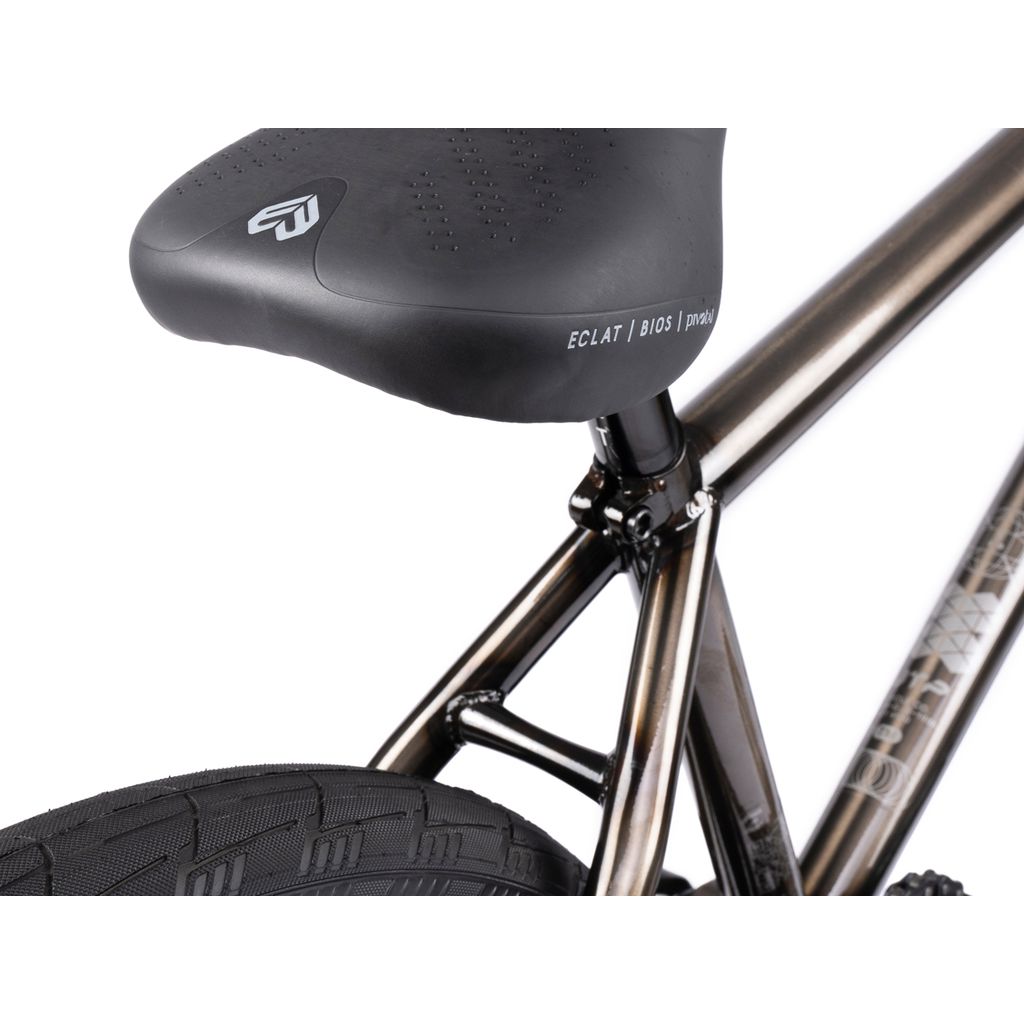 Close-up of a black bicycle seat on a chromoly frame with part of the rear tire, typical of a Wethepeople Envy 20 Inch BMX Bike.