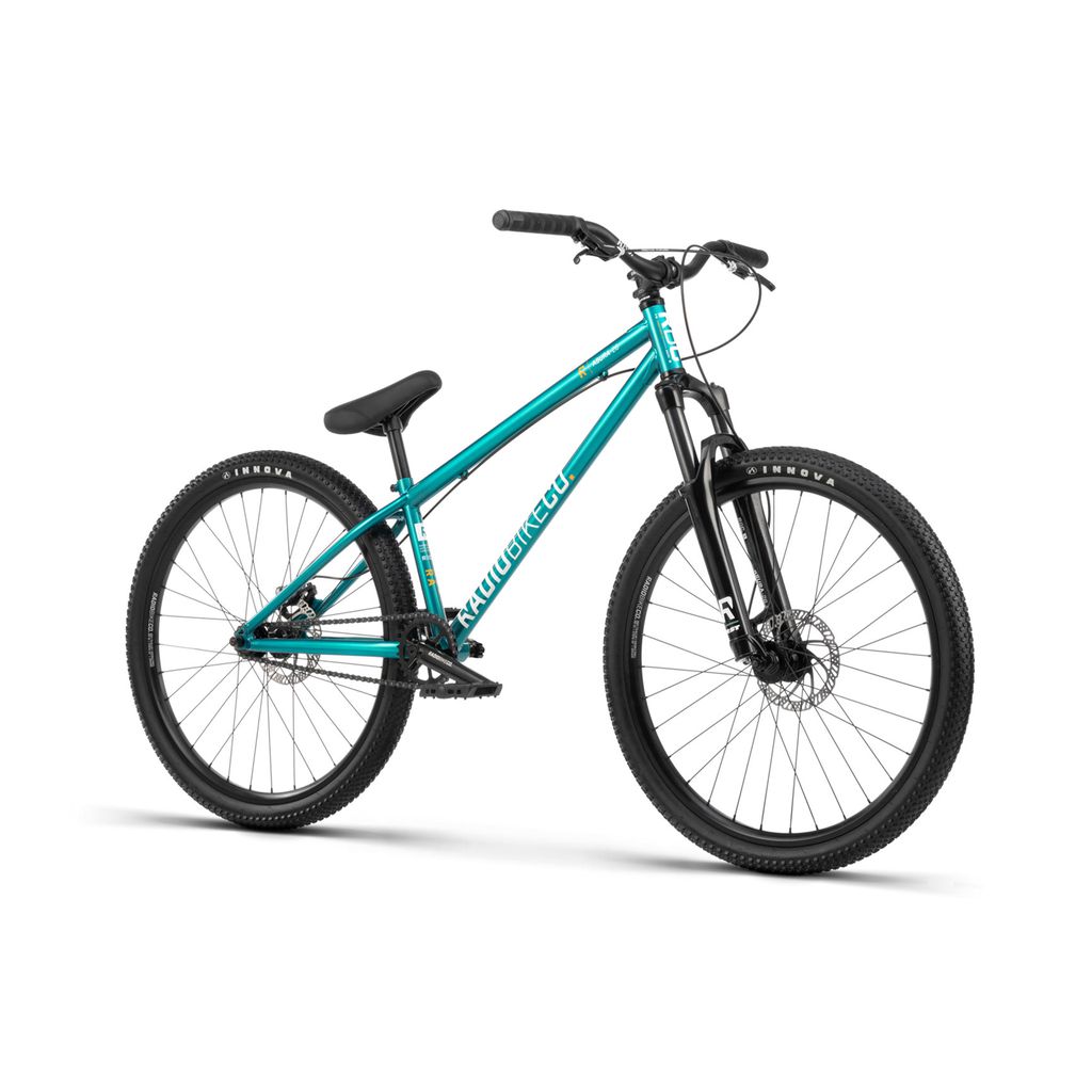 A Radio 26 Inch Asura Bike in teal features a sleek chromoly/steel frame, front suspension fork, and black 26-inch Asura tires equipped with disc brakes, positioned at an angle.