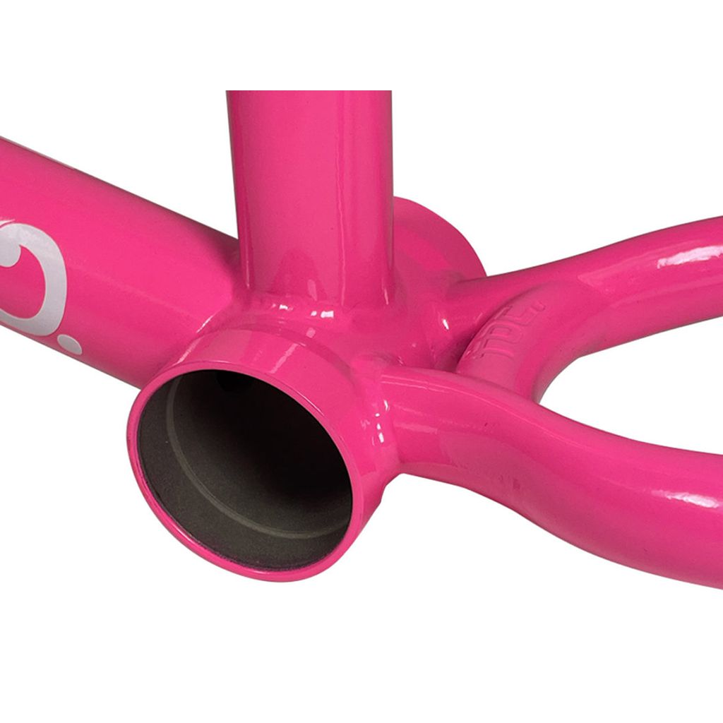 Close-up of a Fit Bike Co Shortcut V2 Frame in pink, highlighting the bottom bracket area. The glossy finish emphasizes the responsive structure admired by tech riders.