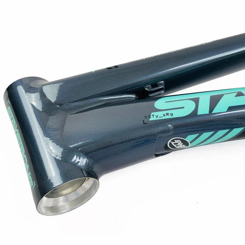 Close-up of a blue and teal aluminium race frame, showcasing the head tube area with clean welds and a glossy finish. The Staystrong V5 Disc Mini Frame is known for its precision engineering, while the disc brake setup ensures top-notch stopping power.