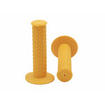 A pair of yellow Kastan Grips bicycle handlebar grips featuring circular patterns, made from era-appropriate rubber—one positioned upright and the other resting horizontally.