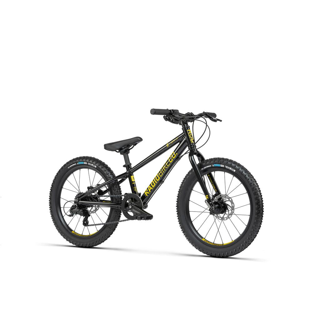 The Radio 20 Inch Zuma Bike is a black children's MTB bike adorned with yellow accents, equipped with thick tires, a padded seat, disc brakes, and a sturdy yet lightweight alloy frame featuring "Armortec" branding.