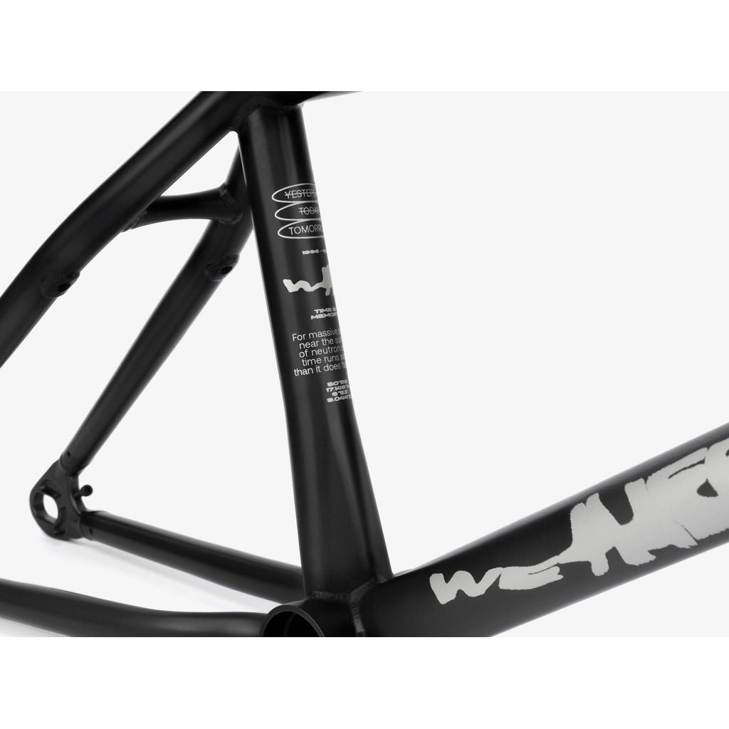 Close-up of the Wethepeople Tomorrow Frame, highlighting its black design with white graphics. It merges BMX influences with modern performance, featuring TA hubs for a seamless ride.