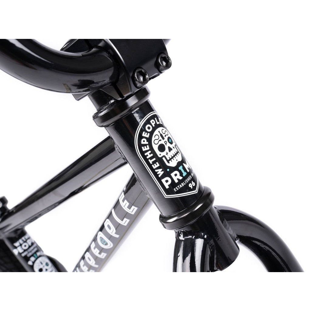 A sleek black balance bike frame branded with a skull design sticker, exemplifying the craftsmanship of the Wethepeople Prime Balance BMX Bike.