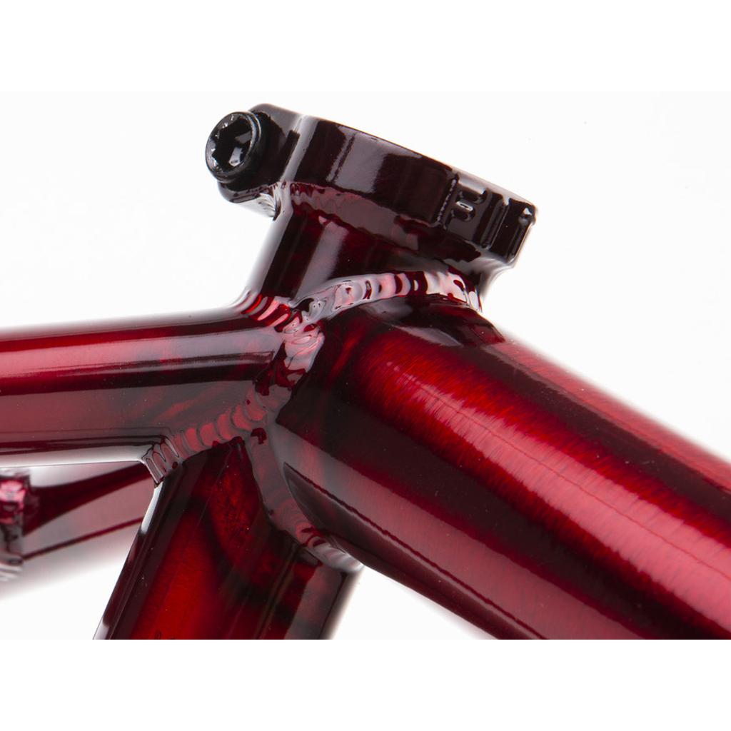 A close-up of the red metallic Fit Bike Co Sleeper (Ethan Corriere) Frame highlights visible welds, a sturdy seat post clamp, and precise chain tensioners.