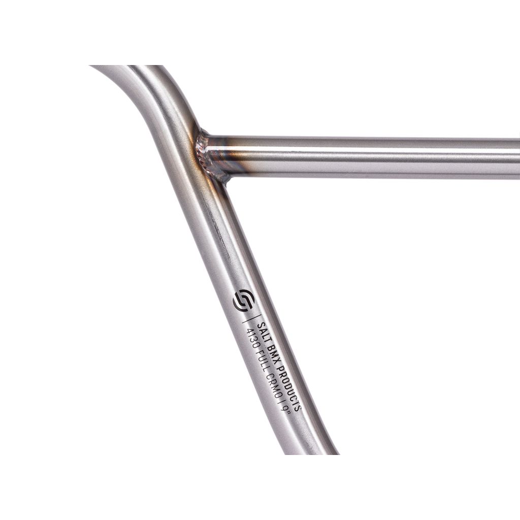 Close-up of a silver metal bicycle frame with visible welds and engraved text "S&M Products, A303FUCOMP019," perfectly complementing the sturdy Salt Pro Bars for an exceptional riding experience.