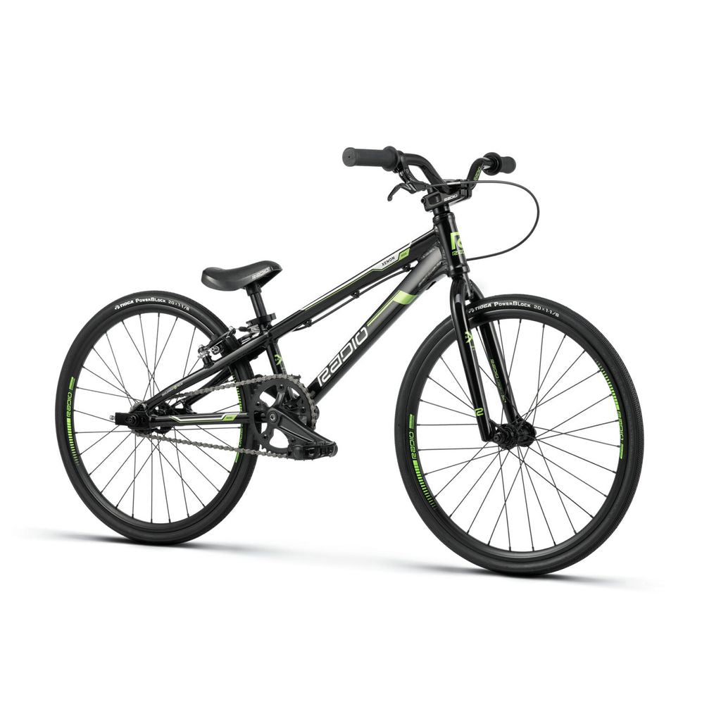 A black Radio Xenon Mini Bike with green accents, front and rear brakes, upright handlebars, and large, thin tires. The frame is crafted from hydro-formed 6061-T6 alloy for enhanced strength and lightweight performance. An ideal blend of style and function for serious riders.