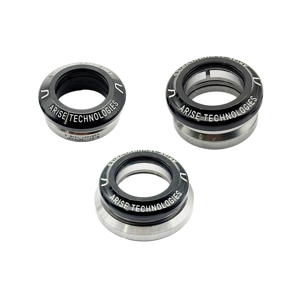 Three CNC machined components labeled "Arise Crystal Integrated Headset 1-1/8 Inch" are arranged on a plain white background. Each circular item features a black ring with white text and metallic rims, resembling an integrated headset.