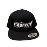 A black snapback hat called the "Animal Bubble Cap," featuring the word "animal" embroidered in white and gray letters on the front. Part of a limited line influenced by hip-hop art, it includes a sticker on the brim that says "Snapback.