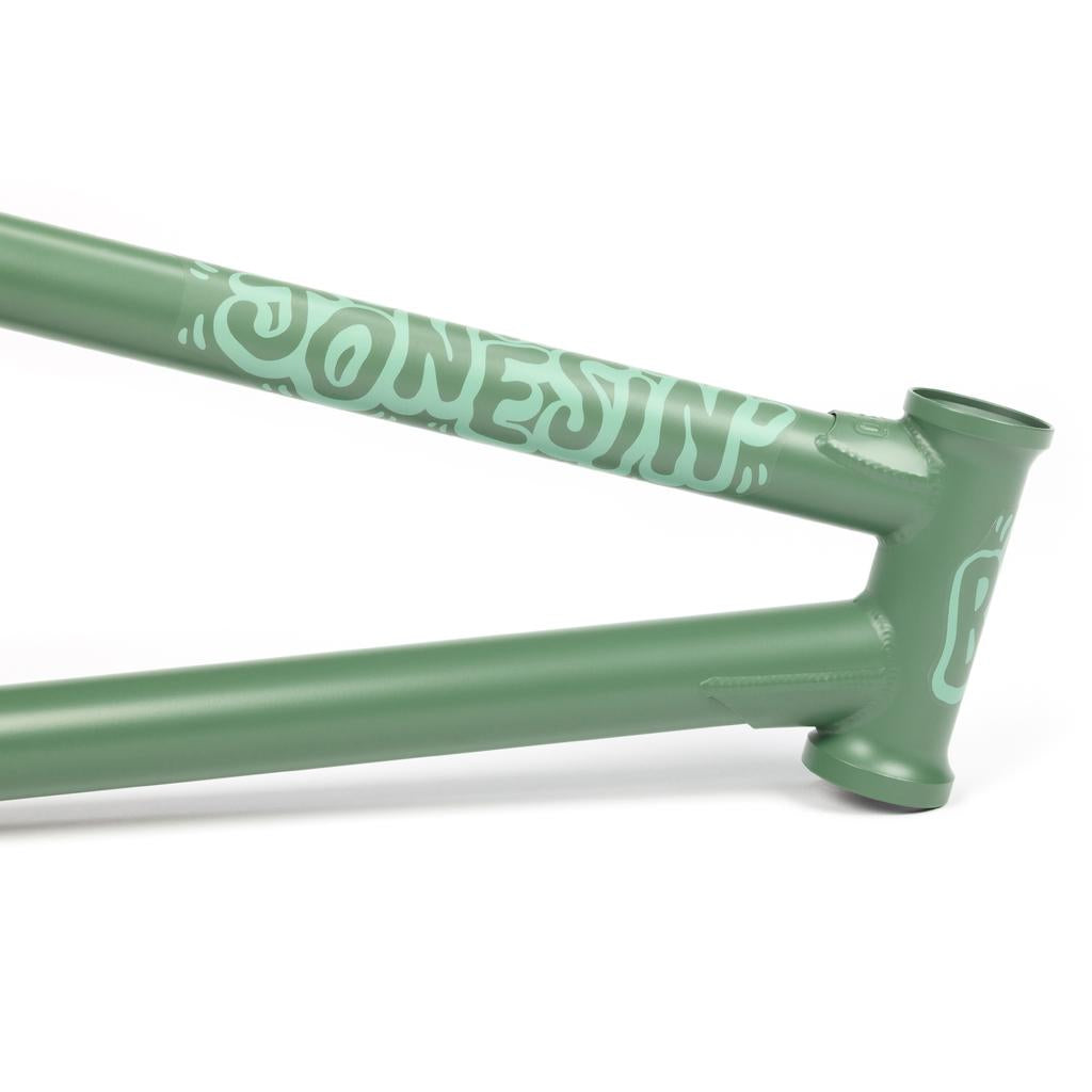 Close-up of a green BSD Jonesin Frame (2021) with a custom design and logo near the head tube, highlighting its modern street geometry.