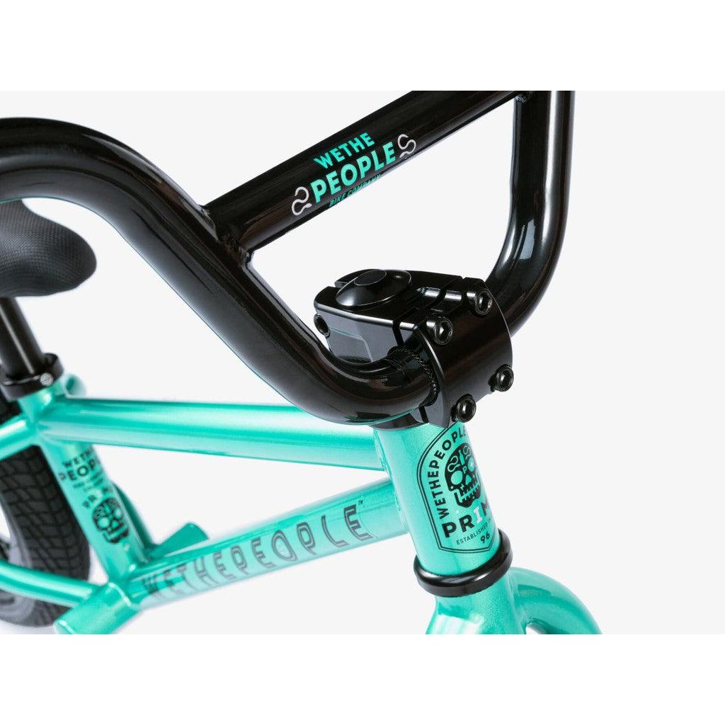 A turquoise Wethepeople Prime Balance BMX bike frame features black handlebars and branding, highlighting its sleek design and performance.