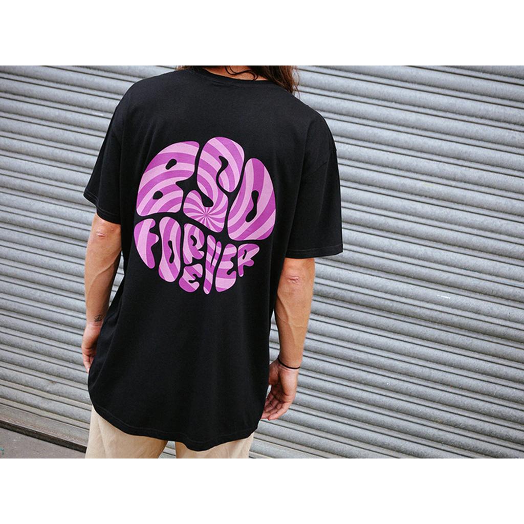 Wearing a BSD Psyched Out T-Shirt with "250 Forever" in a pink psychotic screenprint, one confidently poses against a gray metal shutter, radiating an unmistakable Florida vibe.