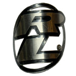 Metal emblem in the shape of an oval with a stylized letter "R" in the center, reminiscent of a Redline Headtube Badge.