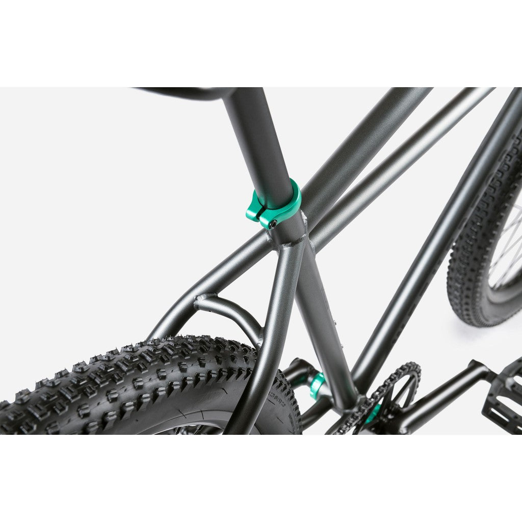 Close-up of the Wethepeople Avenger 27.5 Inch Bike frame with a rear tire, featuring a black matte finish and teal accents on the joints. With disc brakes, this hybrid clunker machine combines style and performance for cycling enthusiasts.