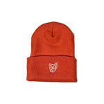 S&M Sharpie Shield Beanie, designed in bright orange and made from hypoallergenic acrylic, features a stylish white embroidered logo on the front.